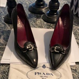Prada black leather pumps with silver buckle.